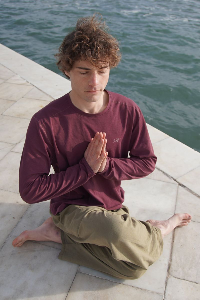 Benji meditating by the sea